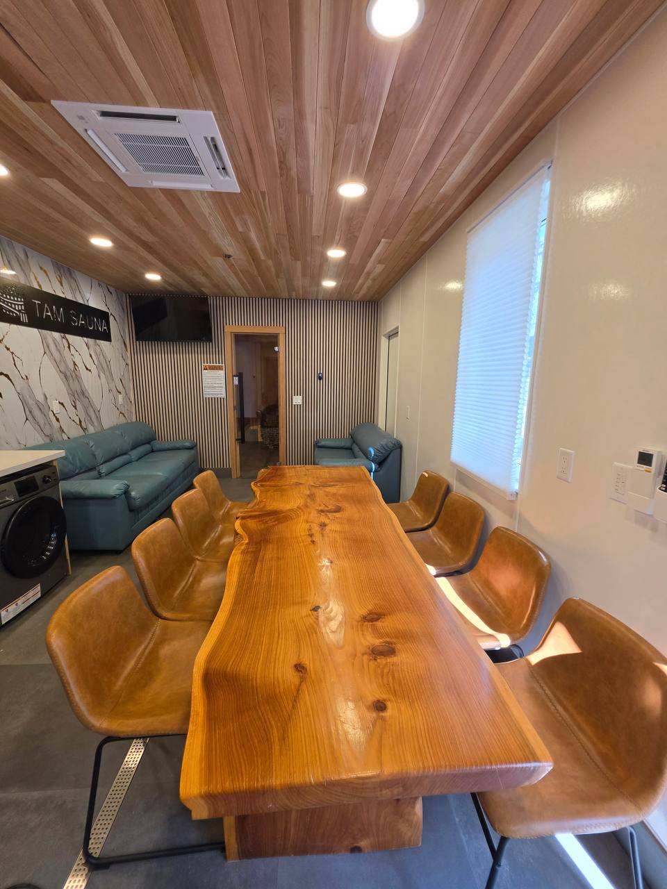 Lounge with a long wooden table and leather chairs