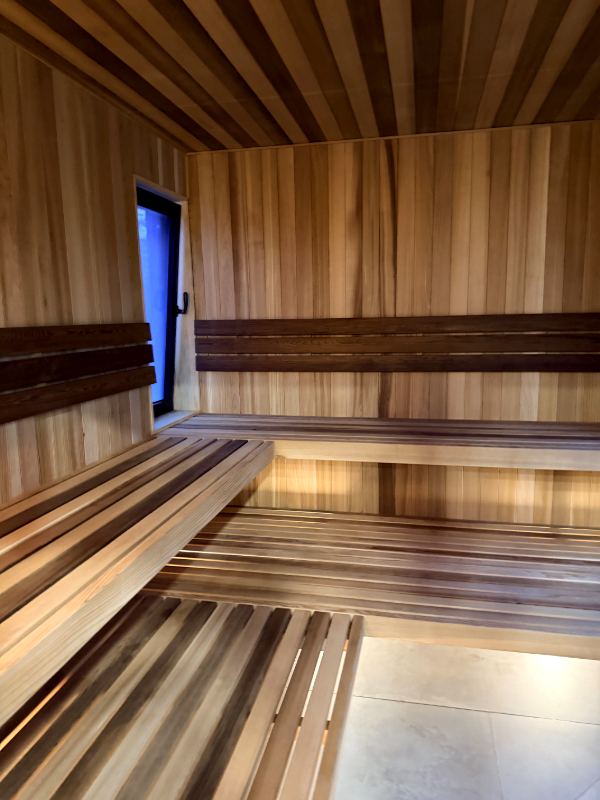 Cedar sauna benches and a tall window