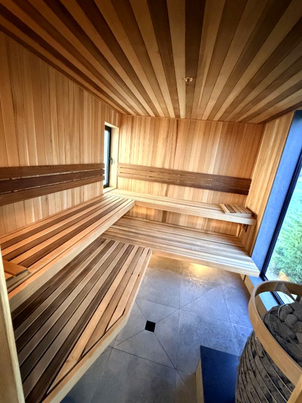 Bright cedar sauna with a window