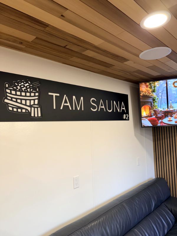 Lounge sofa under the Tam Sauna sign