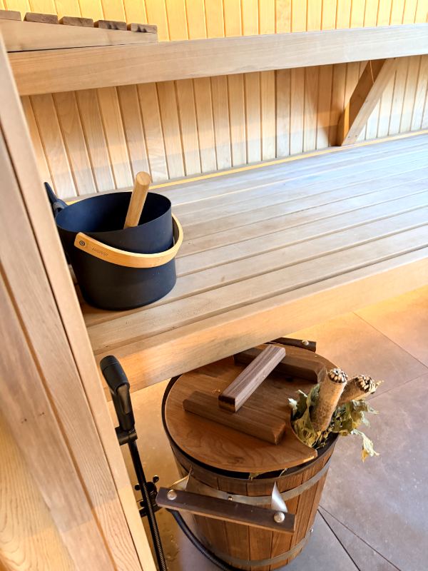 Wooden bucket and ladle in the sauna