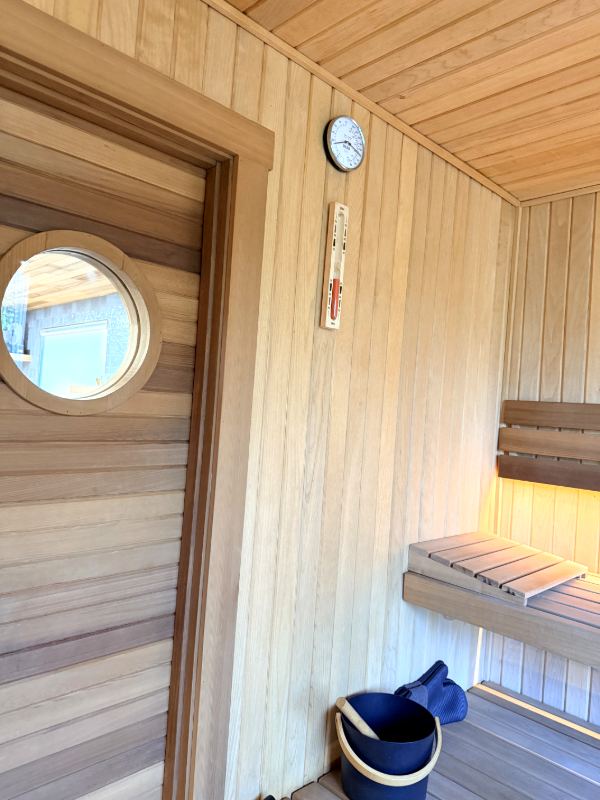Sauna door with a round window