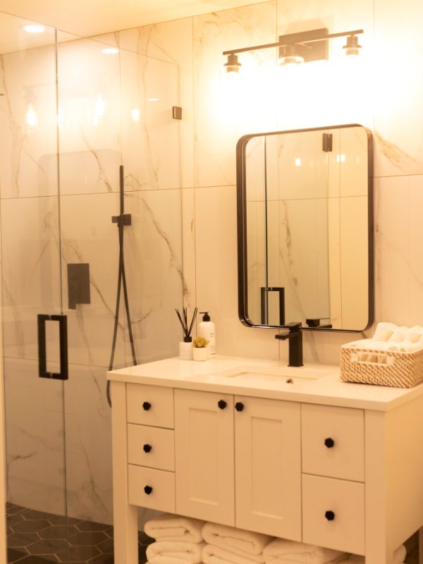 Bathroom with a glass shower and marble walls