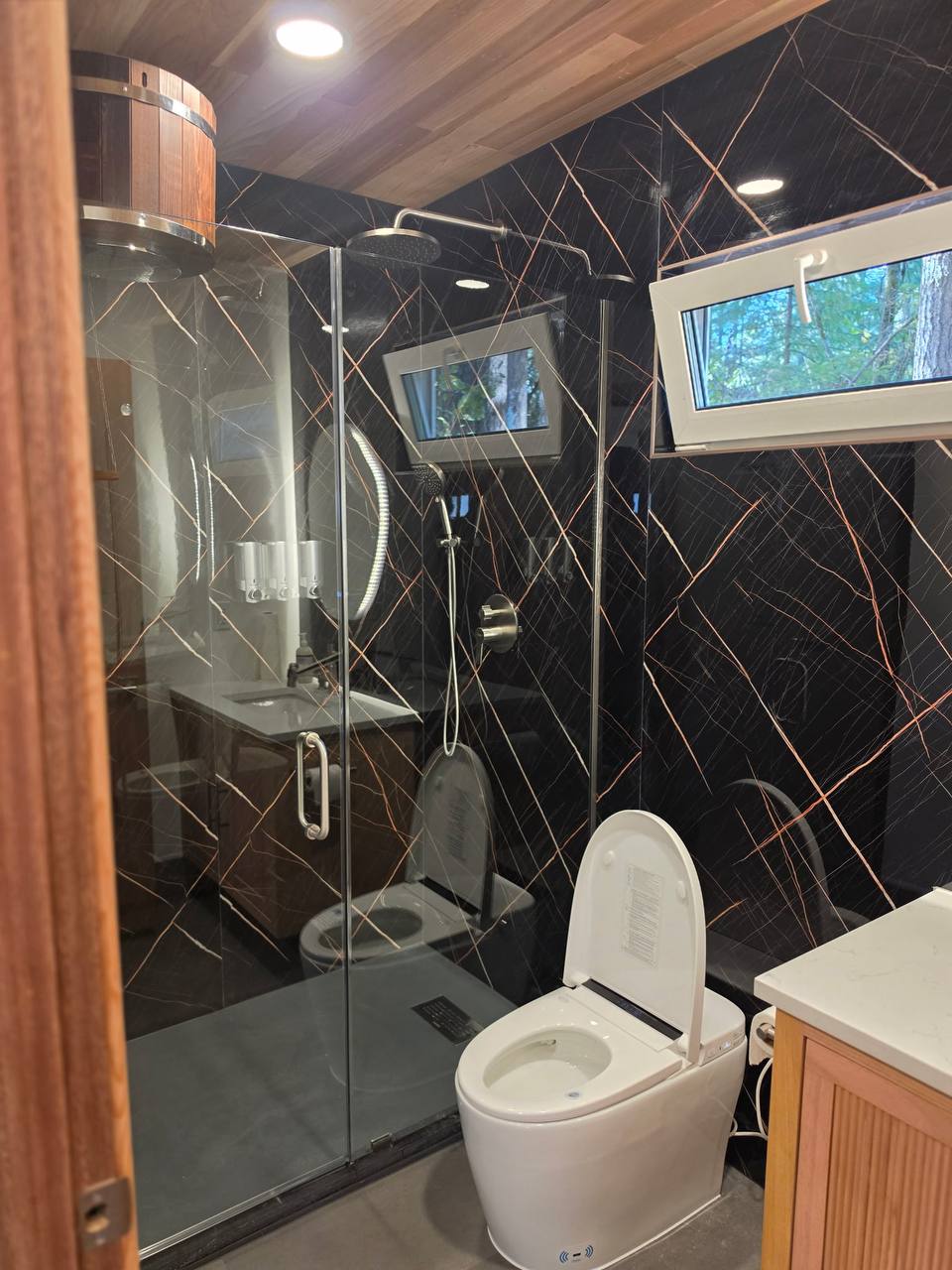 Shower room with black marble walls